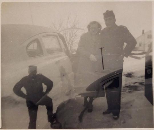 [double exposure- woman and men in military uniform next to car and man in military uniform with foot on bumper of car "C 50 HUDSON STEPDOWN / B00788"]