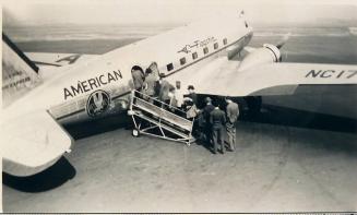 [people boarding American airlines plane on tarmac "OCTOBER 1940"]