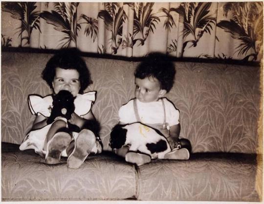 [Two Children and Two Dogs Sitting on Sofa]