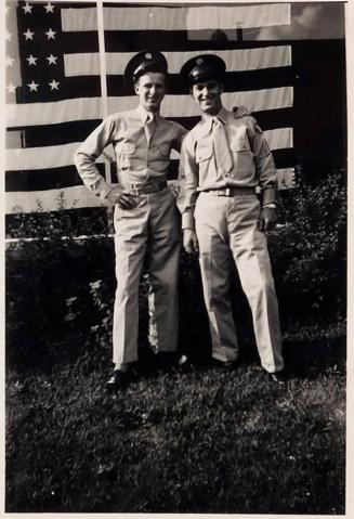 [two men in uniform with arms around each other in front of American flag "Bill & Bud / near the U.S.O. / June 6 1943 / Bill killed / in action/ Germany / Feb. 20 44"]