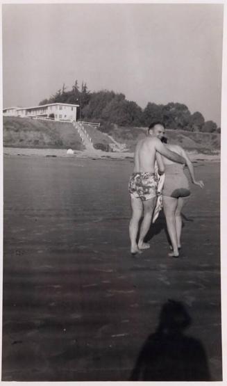 [man and woman walking away from photographer in swimsuits "WET BUTT SHADOW"]
