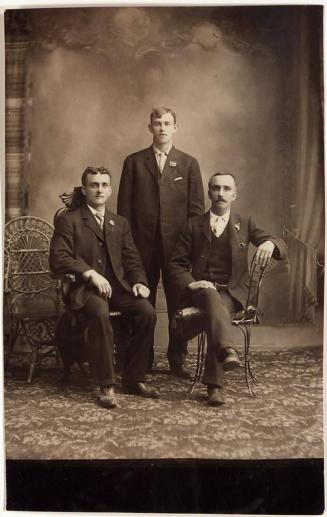 [three men in portrait studio]
