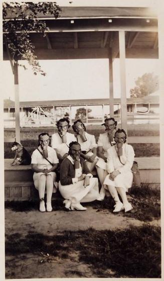 [6 women with gas masks and one dog]