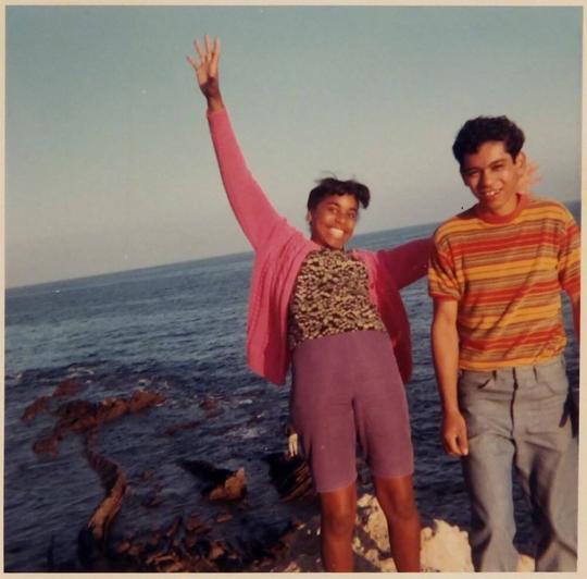 [boy and girl next to body of water]