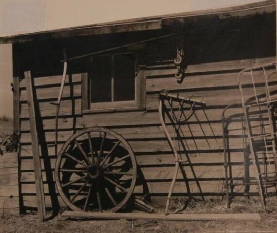 Machinery against the garage on Matt Henry's farm near Tipler, Wisconsin. Note primitive scythe rake