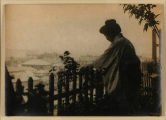 [Woman in Kimono, Leaning Against Fence]