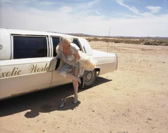 Dixie Evans fixing her shoe, Exotic World, Helendale, Calif.