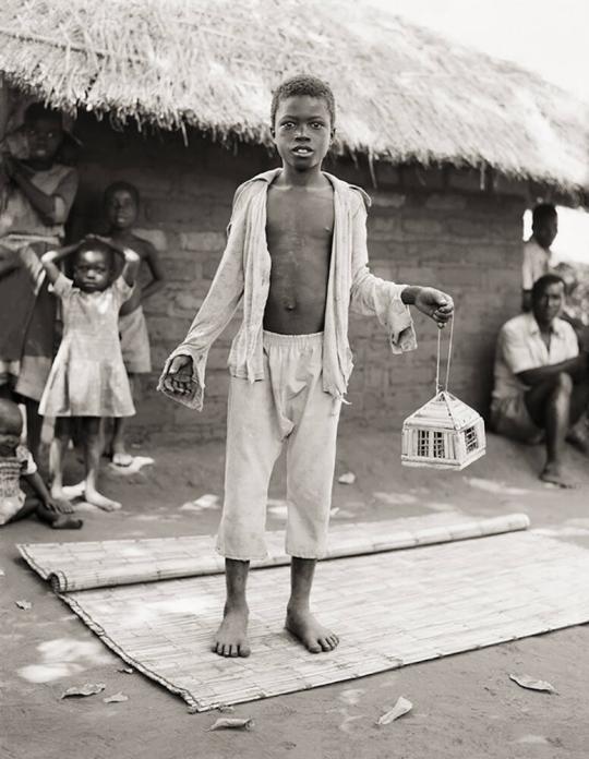 Tony Matayu with Caged Kambuna Birds, Mozambican Refugee Camp, Nyamithuthu, Malawi