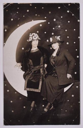 [Two Women with Hats Posing with Large Paper Moon and Stars]