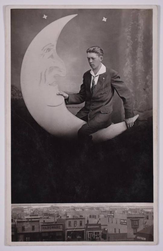 [Young Man Posing with Large Paper Moon and Stars]