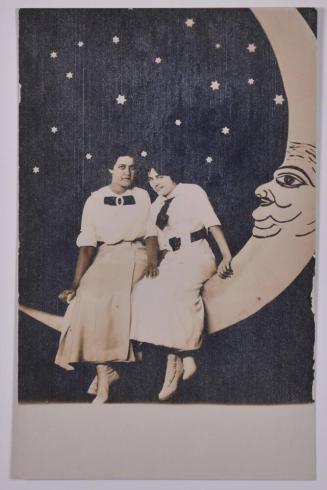 [Two Young Women Posing with Large Paper Moon and Stars]