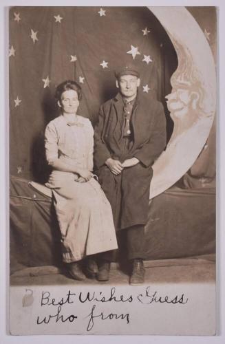 [Woman and Man Posing with Large Paper Moon and Stars]