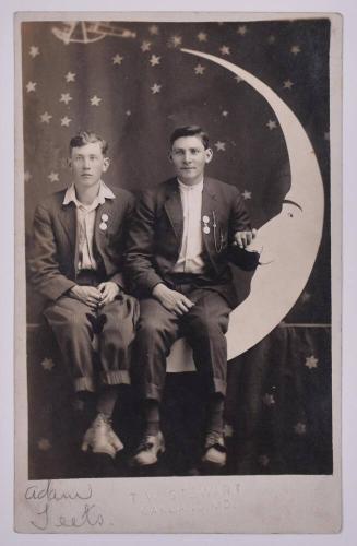 [Two Young Men Posing with Large Paper Moon and Stars]