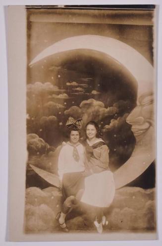[Two Young Women Posing with Large Paper Moon and Stars]