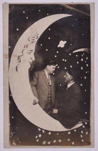 [Two Men Posing with Large Paper Moon and Stars]