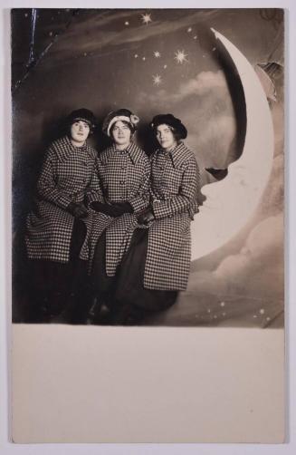 [Three Young Women in Matching Coats Posing with Large Paper Moon and Stars]