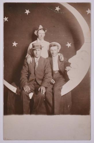 [Three Young Men Posing with Large Paper Moon and Stars]