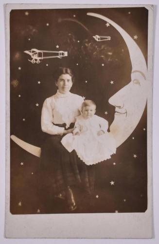 [Woman and Baby Posing with Large Paper Moon and Stars]