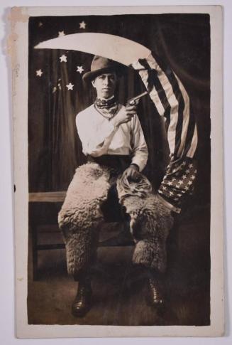 [Man with a Gun and American Flag Posing with Large Paper Moon and Stars]
