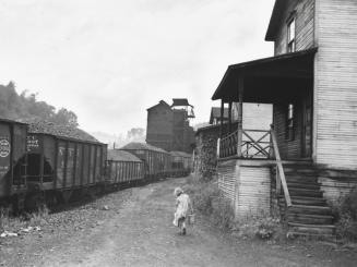 Coal Miner's Child Carrying Home Can of Kerosene, Scotts Run, West Virginia.  Company Owned Houses