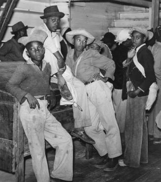 Young boys waiting to be paid off for picking cotton, Marcella plantation store, Mileston, Mississippi
