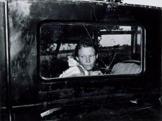 Migrant worker looking through back window of automobile near Prague, Oklahoma. Lincoln County, Oklahoma