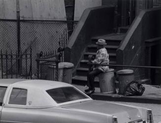 Man Smoking Cigar on Ashcan