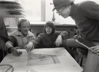 [Earl Staley, Penny Cerling and David Folkman looking at a print of Icarus]