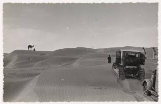 Untitled (Tractor in a desert, camel on sand)