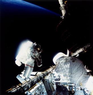 Mission: Space Shuttle 51-A, Discovery: Joseph P. Allen maneuvers near the cargo bay as Dale A. Gardner works in the bay...