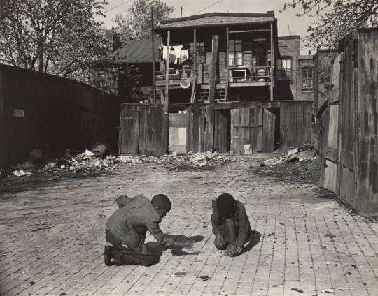 Washington (southwest section), D.C. Two Negro boys shooting marbles in front of their homes