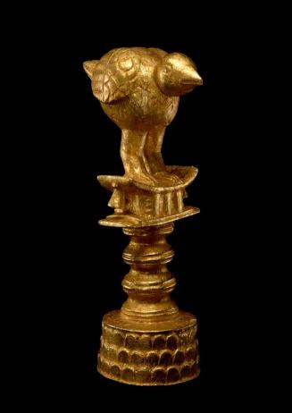 Umbrella finial of a bird on a stool