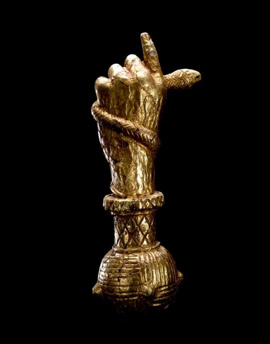 Sword handle of a hand holding a snake