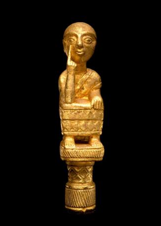 Linguist Staff Finial Representing a Seated Man Pointing at His Eye