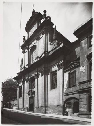 [Old church with man seated on stoop]