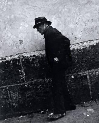 Elderly Man Walking in Front of a Wall with "Fuhrer" on it