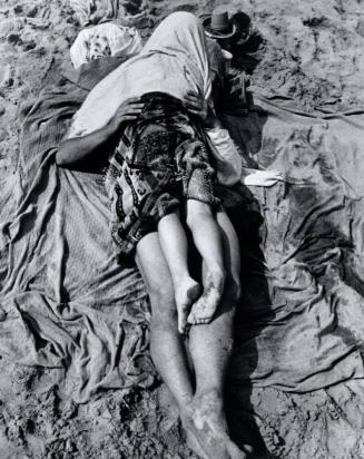 Man Holding a Child Covered with a Towel at Beach