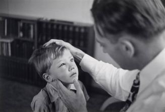 Dr. Ceriani examines boy with swollen eye