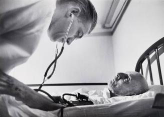 Before the amputation, Dr. Ceriani checks the patient's blood pressure