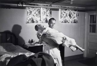 Dr. Ceriani carries a patient from basement ward to operating room