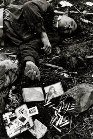 Fallen North Vietnamese soldier, his personal effects scattered by body-plundering soldiers, South Vietnam