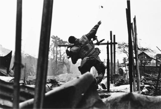 American Marine throwing hand grenade, Tet Offensive, Hue, South Vietnam
