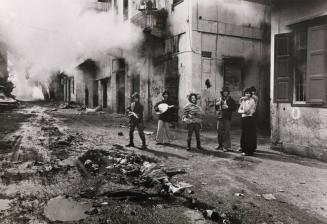 Christian militia mock the body of a young Palestinian girl killed in the battle of Karantina, Beirut