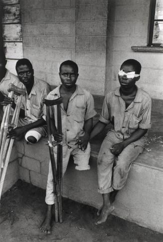 Crippled and maimed soldiers waiting for food handouts at a Catholic mission, Republic of Biafra
