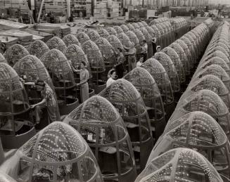Women aircraft workers finishing transparent bomber noses for fighter and reconnaissance planes at Douglas Aircraft Co. Plant in Long Beach, Calif.
