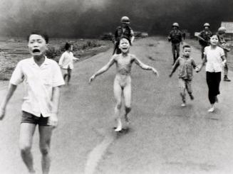 Phan Thi Kim Phuc (center) flees from the scene where South Vietnamese planes have mistakenly dropped napalm