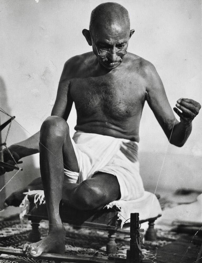 Gandhi using his spinning wheel at home | All Works | The