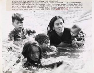 A Vietnamese Mother and Her Children Escape Bombs from a U.S. Air Strike, South Vietnam