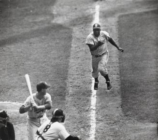 Brooklyn Dodger Jackie Robinson Charging Wildly from Third Base as Unwary NY Yankee Catcher Yogi Berra Squats behind Dodger Batter during Jackie's Steal of Home Plate during Eighth Inning of the First Game of the World Series at Yankee Stadium