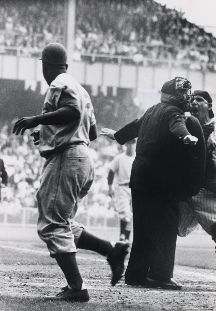 Yankee manager Yogi Berra (8) signals the bullpen for a new hurler